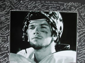 Walter Lumsden is shown in his Lakeshore Gators uniform in a photo that was signed by dozens of people at a fundraiser for him in 2011. Lumsden, who was seriously injured in a swimming accident in August, 2011, died Tuesday. (Pam Koudijs/Special to QMI Agency)