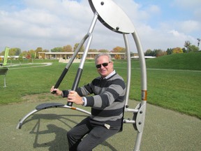 Bob Crawford, general manager of community development for Chatham-Kent, poses with a piece of exercise equipment at Kingston Park on Oct. 16. The municipality held a ribbon-cutting ceremony to mark the official opening for the equipment.