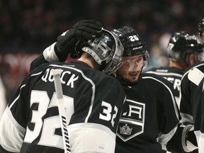 Goalie Jonathan Quick #32 of the Los Angeles Kings is congratulated by Slava Voynov #26 after Quick's shutout against the St. Louis Blues at Staples Center on October 16, 2014 in Los Angeles, California. (Stephen Dunn/Getty Images/AFP)