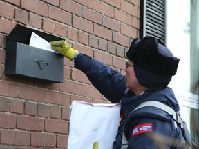 Canada Post announced it will stop door-to-door delivery of the mail in urban areas on December 11, 2013. (Veronica Henri/QMI Agency Files)
