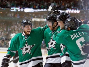 (L-R) Tyler Seguin #91 of the Dallas Stars; Patrik Nemeth #37 of the Dallas Stars; Jamie Benn #14 of the Dallas Stars; and Trevor Daley #6 of the Dallas Stars celebrate after Benn scored against the Anaheim Ducks in the first period in Game Three of the First Round of the 2014 NHL Stanley Cup Playoffs at at American Airlines Center on April 21, 2014 in Dallas, Texas.  (Tom Pennington/Getty Images/AFP)