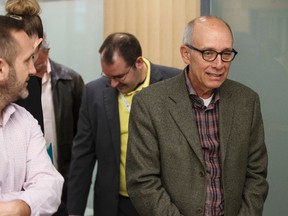 Minister of Health Stephen Mandel (right) waits in line for a flu shot during an Alberta Health Services press conference launching Alberta's Influenza Immunization Program at Woodcroft Public Health Centre in Edmonton, Alta., on Monday, Oct. 20, 2014. Clinics are now open across the province, offering influenza free of charge to Albertans over the age of six months. Ian Kucerak/Edmonton Sun