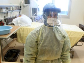 Infectious control nurse Lori Fleetwood waits to exit a containment room during a media demonstration on Ebola preparedness at the Health Sciences Centre. (Brian Donogh/Winnipeg Sun)
