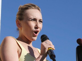 Cancer survivor Carley Allison, a first-year Queen’s University student, sings O Canada during the opening ceremonies at the Ride to Conquer Cancer in Toronto on June 7. More than 5,000 cyclists raised $20 million in the event. (Veronica Henri/QMI Agency)