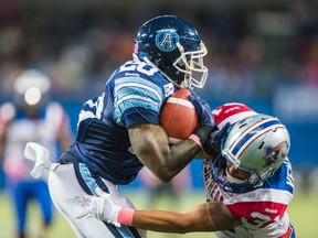 Argonauts’ Steve Slaton (left) and Montreal Alouettes Winston Venable mix it up during Saturday’s game in Toronto. The Boatmen, at 6-9 with three games remaining in the regular season, hope to win out to avoid potentially missing the playoffs. (ERNEST DOROSZUK/TORONTO SUN)
