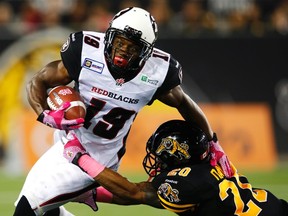 RedBlacks' Roy Finch  is tackled by Hamilton Tiger-Cats' Emanuel Davis during CFL action in Hamilton, October 17.   (REUTERS)