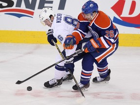 Edmonton's Mark Arcobello wraps up Tampa Bay's Nikita Kucherov during Monday's NHL action at Rexall Place (David Bloom, Edmonton Sun).