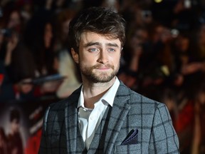 British actor Daniel Radcliffe poses for photographers on the red carpet as he arrives for the U.K. premier of 'Horns' in central London on October 20, 2014. (AFP PHOT /BEN STANSALL)