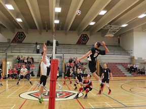 As college sports swings into its busiest weekend of the fall and high school football teams prepare for upcoming playoff battles, the top senior high school volleyball teams will stage what might a classic tonight. The Jasper Place Rebels, here shown defeating Spruce Grove, are ranked second in the province and are playing host to the top-rated Strathcona Lords. (Courtesy Matt Burrows, Jasper Place High School)