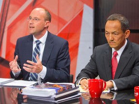 Mayoral candidate Paul Cheng, right, listens as fellow candidate Matt Brown, left, speaks during a televised debate at the Rogers TV London studio in London on Tuesday. (CRAIG GLOVER/THE LONDON FREE PRESS)