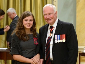 Sgt. Ronald Duchesne, Rideau Hall Hailey Nicole Menard, of Havelock, receives her medal of bravery Tuesday from Governor General David Johnston. (QMI Agency)