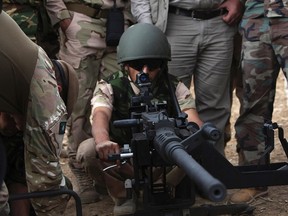 A Kurdish Peshmerga fighter undergoes training by British soldiers at a shooting range in Arbil, in Iraq's northern autonomous Kurdistan region, October 16, 2014. British army trainers have begun teaching Kurdish Peshmerga fighters how to fire and maintain heavy machineguns, as part of their fight against Islamic State (IS) militants. (REUTERS/Azad Lashkari)