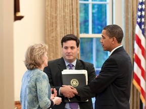 U.S. President Barack Obama (R) meets with Ron Klain, then chief of staff to the vice president, and Cynthia Hogan, counsel to the vice-president, in the Oval Office, in this May 21, 2009 photograph. REUTERS/Pete Souza/White House/Handout via Reuters