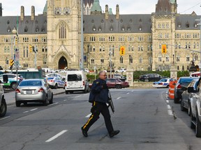 Police have locked down Parliament Hill after shootings in Ottawa, Oct. 22, 2014. (MATTHEW USHERWOOD/QMI Agency)