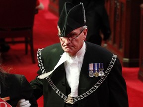 Sergeant-at-Arms Kevin Vickers leads Senate page Brigette DePape (not shown) from the Senate chamber on Parliament Hill in Ottawa in this file photo from June 3, 2011.  According to Veterans Affairs Minister Julian Fantino, Vickers shot dead one of the suspects in the October 22, 2014 shooting incident on Parliament Hill.  A gunman shot and wounded a soldier in Ottawa and then entered the country's parliament buildings chased by police, with at least 30 shots fired.  (REUTERS/Chris Wattie/Files)