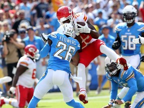 Running back Jamaal Charles #25 of the Kansas City Chiefs dives around cornerback Brandon Flowers #26 of the San Diego Chargers to score a touchdown to finish a 16 yard run in the second quarter at Qualcomm Stadium on October 19, 2014 in San Diego, California.   (Stephen Dunn/Getty Images/AFP)