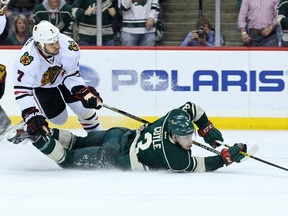 Minnesota Wild forward Charlie Coyle (3) passes the puck in front of Chicago Blackhawks defenceman Brent Seabrook (7) in this 2013-14 file photo. (Brace Hemmelgarn-USA TODAY Sports)