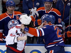 Matt Hendricks trades blows with Capitals Liam O'Brien during the first period of Wednesday's game at Rexall Place. (David Bloom, Edmonton Sun)