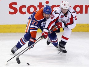 Oilers centre Boyd Gordon checks the Capitals' Jay Beagle during third-period action Wednesday at Rexall Place. (David Bloom, Edmonton Sun)