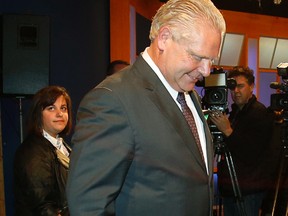 Mayoral candidate Doug Ford leaves the media scrum after the debate. Jennifer Pagliaro, left, can be seen behind him. (CRAIG ROBERTSON/Toronto Sun)