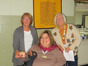 The Optimist Club of Sombra Township has begun the 2014–2015 term with the induction of its new president and board members. Past Optimist President Johanne Leach, left, passes the gavel to new Sombra Optimist President Carla Aarssen, centre, as Lt. Governor Mary Lou Abrams looks on. President Carla Aarssen and members of the club’s board were inducted to their positions at the monthly dinner meeting held Monday October 6th, 2014 at a ceremony conducted by Mary Lou Abrams, Optimist Lieutenant Governor of Zones 5/6. President Aarssen noted that “we are always on the lookout for new Optimist members to join our club and support our local youth which is the Optimist Club’s main objective.” Anyone wishing to obtain further information on becoming a member of the Sombra Optimist Club can please contact President Carla at 519-892-3536 or email her at caarssen@hotmail.com