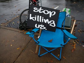 A sign is seen on an empty chair across from the police department in Ferguson, Missouri October 14, 2014. (REUTERS/Shannon Stapleton)