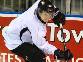 Mitch Marner digs for the puck behind the net during a London Knights practice at Budweiser Gardens in London, Ont. on Wednesday, October 22, 2014. (MIKE HENSEN, The London Free Press)