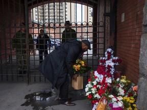 A man leaves flowers at the gate to the The Argylls of Canada - 91st Canadian Highlanders? regiment in Hamilton, Ont. on Wednesday October 22, 2014. This is where Cpl. Nathan Cirillo, the soldier killed at the National War Memorial was based out of.  Ernest Doroszuk/Toronto Sun/QMI Agency