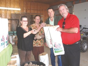 Ruth Leatham, left, Jan Vander, head chef at Beattie Haven, Richard Leatham, and Glenn Degraw, administrator at Beattie Haven, show off bags of potatoes the Leathams and Dixon Feed Service in West Lorne donated to Beattie Haven. The potatoes were grown this year from surplus seed potatoes.