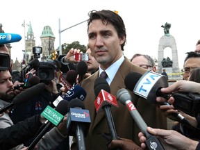Liberal Party of Canada leader Justin Trudeau talks to the media after laying a wreath at the Canadian War Memorial in Ottawa the day after a soldier was murdered. Thursday October 23, 2014. Errol McGihon/Ottawa Sun/QMI Agency