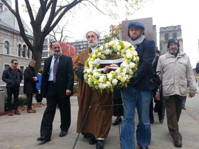 Muslim leaders carry a wreath from the human rights monument outside Ottawa City Hall to the National War Memorial on Thursday, Oct. 23, 2014. JON WILLING/OTTAWA SUN