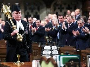 Sergeant-at-Arms Kevin Vickers is applauded in the House of Commons in Ottawa, Oct. 23, 2014. (CHRIS WATTIE/Reuters)