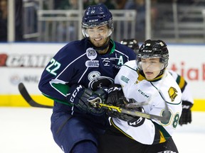 Plymouth Whalers forward Matt Mistele gets tied up with London Knights defenceman Victor Mete during an OHL game at Budweiser Gardens on September 26, 2014. (Craig Glover/London Free Press/QMI Agency)