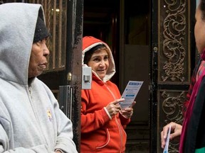 Members of the New York City Department of Health speak to neighbors of a Health Care worker who is suspected to have Ebola in in the Harlem section of New York, October 22, 2014.    REUTERS/Brendan McDermid