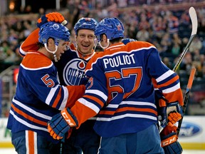 Oilers off-season veteran acquisitions Mark Fayne, Nikita Nikitin and Benoit Pouliot celebrate a Fayne pre-season goal in September at Rexall Place. (USA TODAY)