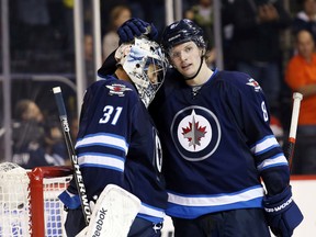 Jacob Trouba (right) and Ondrej Pavelec are two of the key players for the Jets in Tuesday's matchup with the Montreal Canadiens.