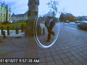 A man identified by Royal Canadian Mounted Police as Michael Zehaf-Bibeau is seen October 22, 2014 as he exits a car and runs toward the Parliament buildings in a still image taken from surveillance video released by the RCMP October 23, 2014. The gunman in Wednesday's attack on Canada's capital Ottawa acted alone and there was no apparent link to an attack in Quebec earlier in the week, security officials said on Thursday. Michael Zehaf-Bibeau, 32, was a Canadian citizen who may also have held Libyan citizenship, said Bob Paulson, commissioner of the Royal Canadian Mounted Police.  REUTERS/CBC via Reuters TV