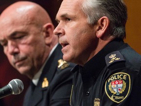 Ottawa Police Service Chief Charles Bordeleau (R) and Royal Canadian Mounted Police Commisioner Bob Paulson speak to the media at RCMP headquarters in Ottawa one day after Cpl. Nathan Citillo was gunned down at the National War Memorial.  October 23, 2014. Errol McGihon/Ottawa Sun/QMI Agency