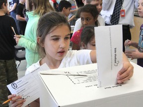 Ainslee Brown, a Grade 3 student at Ecole Sir John A. Macdonald School, votes in a mock municipal election at the school Thursday. About 250 students cast their ballots. (Michael Lea/The Whig-Standard)