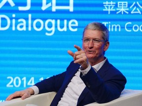Apple CEO Tim Cook gestures as he speaks at Tsinghua University in Beijing October 23, 2014. REUTERS/China Daily