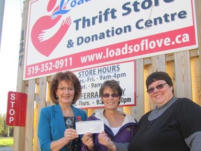 Nancy Standard, left, Lieutenant Grand Prior of Canada of the Hospitaller Order of St. John of Jerusalem, presents a $1,000 donation on behalf of the order to Sue Cornelius, manager of referral programs at Loads of Love and Grace Martin, board member and volunteer. The money will go toward Loads of Love's mattress program.