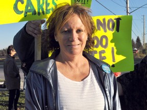 Donna Szpakowski, Ward 7 candidate and president of the Hyde Park Business Association, stands with other members of the “Red Light Movement” at the corner of Hyde Park Road and South Carriage Road in London Ont. October 23, 2014. The group is petitioning for street lights at the intersection. CHRIS MONTANINI\LONDONER\QMI AGENCY