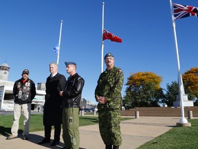 Graeme Hume of the Highway of Heroes Ride, CFB Trenton base commander Col. David Lowthian, with Quinte West Mayor John Williams and CFB Trenton acting chief warrant officer Jean Lafond remember the deaths of two Canadian soldiers killed on home soil this week – Cpl. Nathan Cirillo and WO Patrice Vincent. A ceremony was held at the Cenotaph in Trenton, ON., Friday, Oct. 24, 2014. 
Emily Mountney-Lessard/The Intelligencer/QMI Agency