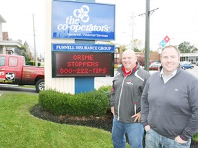 Const. Jim Robb, OPP coordinator with Crime Stoppers of Oxford, and Adam Funnell, owner of Funnel Insurance Group – The Co-operators in Ingersoll, stand in front of a digital billboard in front of Funnell's Charles Street office that is helping keep Crime Stoppers in the public eye on a daily basis. JOHN TAPLEY/INGERSOLL TIMES/QMI AGENCY
