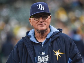 Tampa Bay Rays manager Joe Maddon (70) watches from the dugout during MLB action against the Oakland Athletics at O.co Coliseum. (Kyle Terada/USA TODAY Sports)