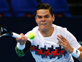 Milos Raonic returns the ball to David Goffin of Belgium during their match at the Swiss Indoors tennis tournament in Basel October 24, 2014.  (REUTERS/Arnd Wiegmann)