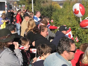 Hundreds of people keep vigil as they wait for the hearse containing the body of Cpl Nathan Cirillo to pass under Highway 38 at the city's west end Friday afternoon on its way from Ottawa to Hamilton. FRI., OCT 24 2014 KINGSTON, ONT. MICHAEL LEA THE WHIG STANDARD QMI AGENCY