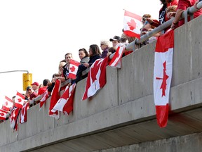 A large crowd waits at the Stewart Boulevard overpass for the procession bearing the remains of Cpl Nathan Cirillo. (DARCY CHEEK/The Recorder and Times)