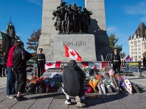 Sentries return to the Tomb of the Unknown Soldier during a ceremony at the National War Memorial in Ottawa October 24, 2014.  Canadian soldier Cpl. Nathan Cirillo was shot and killed at the National War Memorial on October 22,October 24, 2014. Errol McGihon/Ottawa Sun/QMI Agency