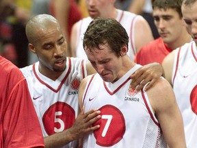 Sherman Hamilton (left) consoles Steve Nash after a loss at the 2000 Olympic Games. (Fred Thornhill/Toronto Sun)
